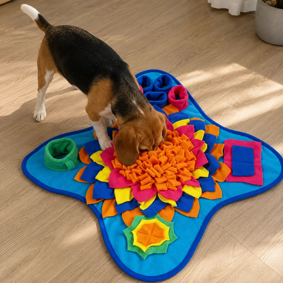 A beagle with its nose deep in the Ocean snuffle mat, tail up