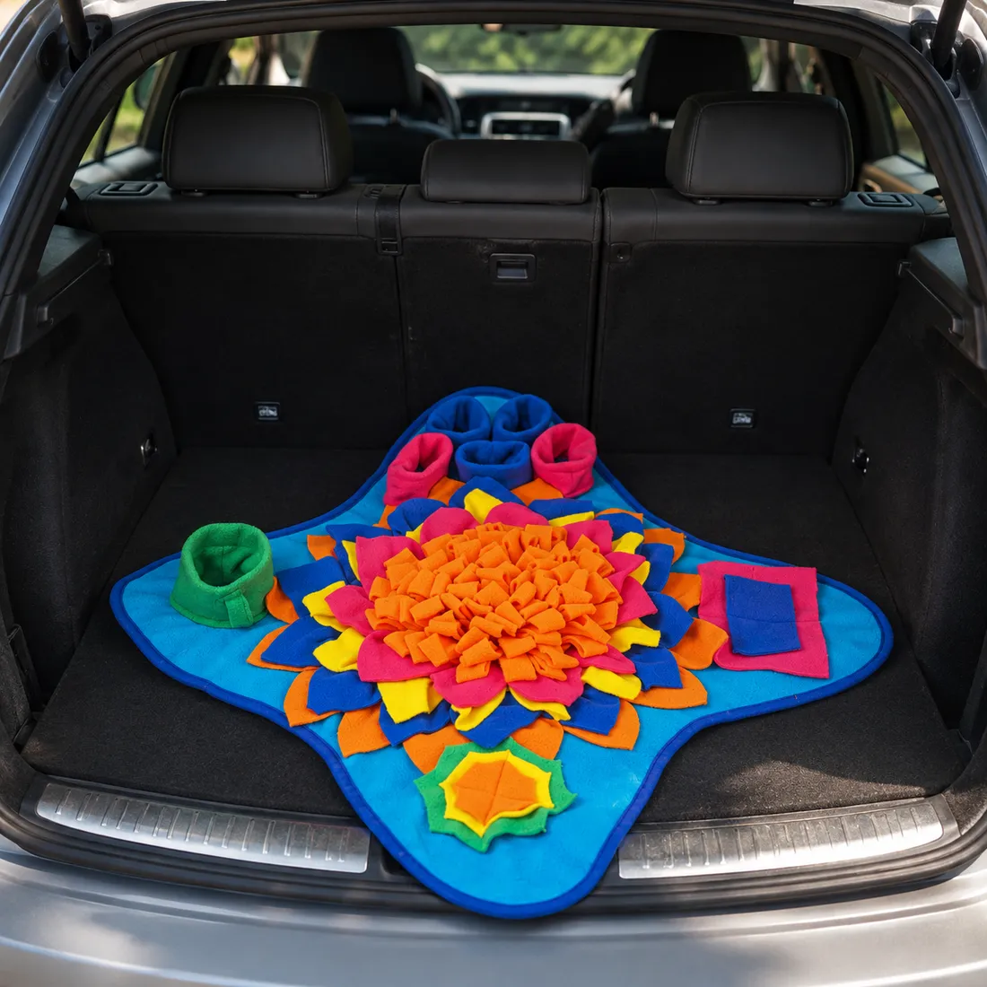The Ocean snuffle mat laid flat in the open trunk of an estate car